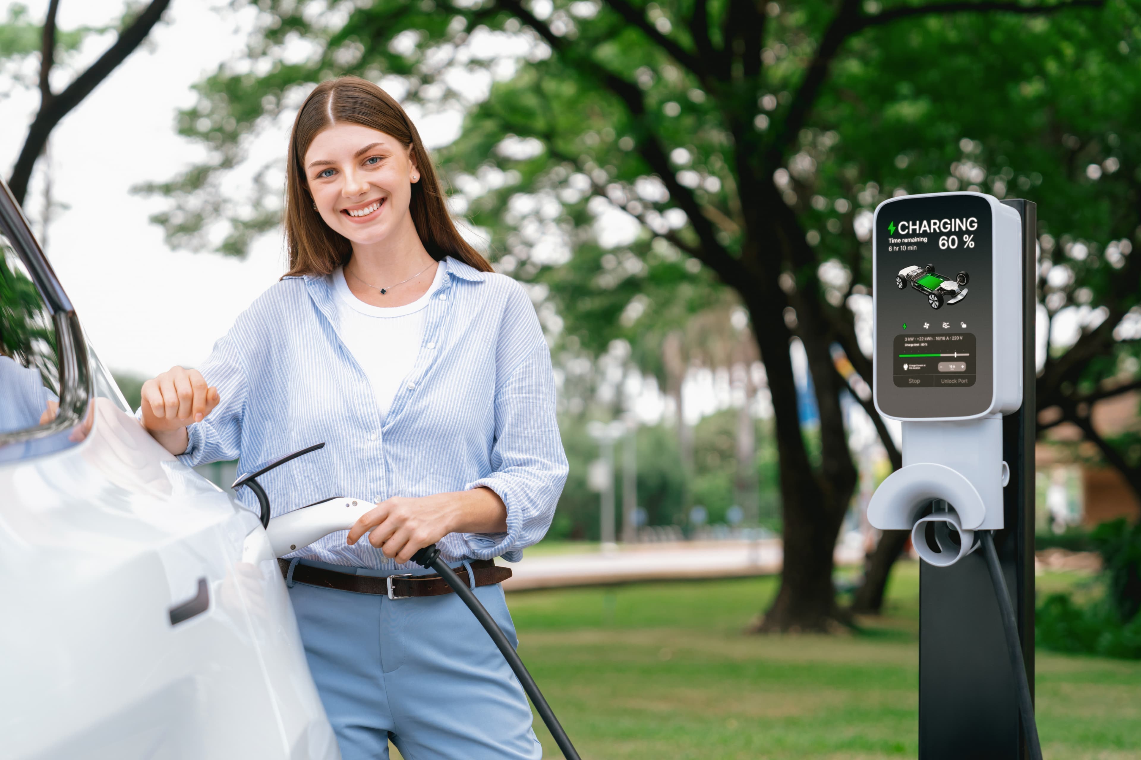 Driver standing beside an EV